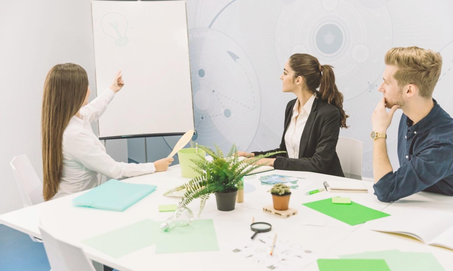 Professional team analyzing financial data and capital budgeting scenarios in modern office environment